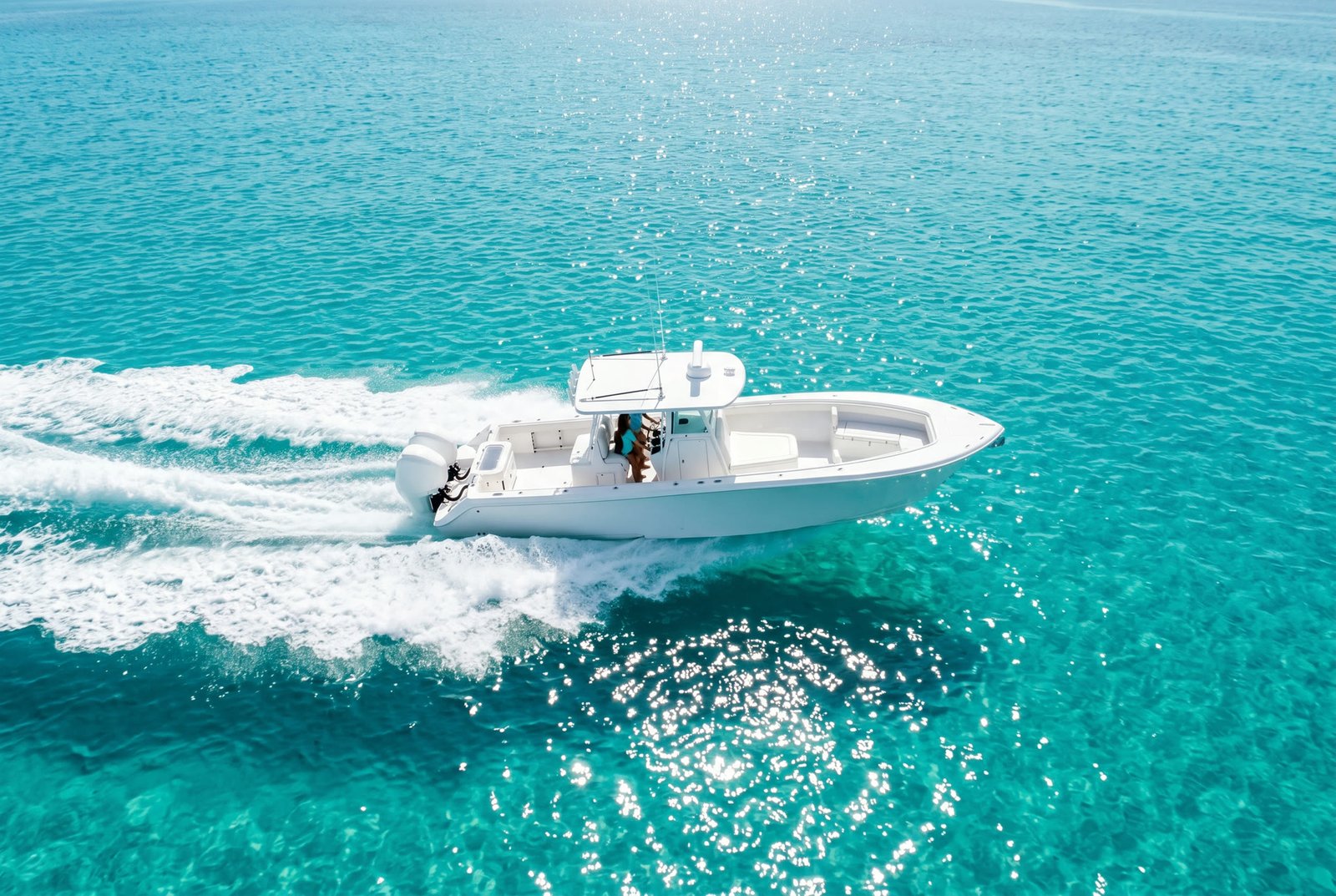 The boat running fast across turquoise water with a white wake